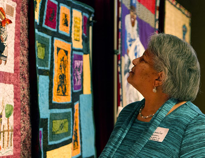 Pasadena resident Marcie Gordon Ambrose surveys a historical mural during the 14th annual “Discover Your Roots” conference in L.A. March 12. (Photo by Mike Hammari)