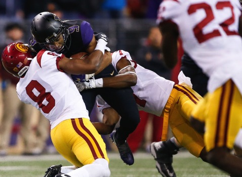 USC defensive back Iman Marshall (8) wraps up Washington running back Myles Gaskin in the Trojans 26-13 victory against the fourth-ranked Huskies Nov. 12. The Trojans go looking for their seventh straight victory Nov. 19 against UCLA. (Courtesy photo)