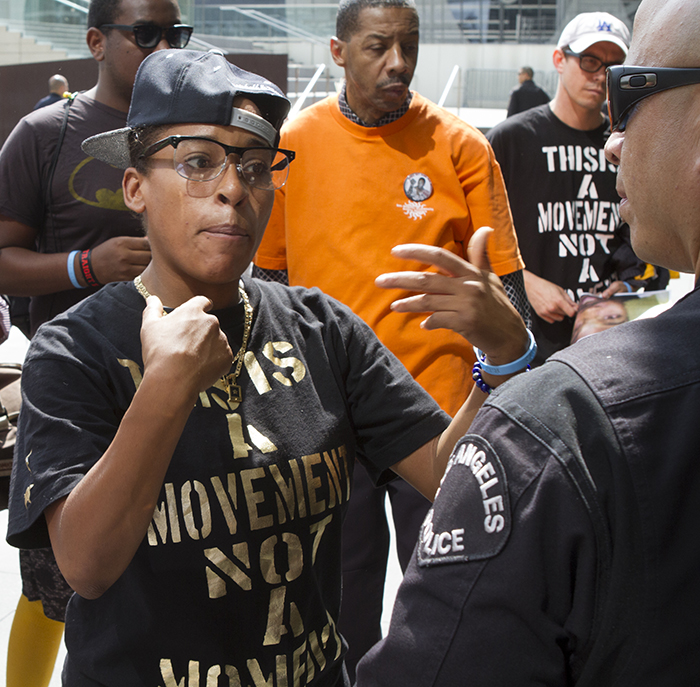 Jasmine Richards of Black Lives Matter gets in the face of a Los Angeles police officer outside the Police Commission meeting Aug. 11. The organization is bringing a new energy and focus to community activism is the black community.
(Photo by Gary McCarthy)