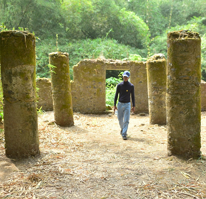 Sculptor Nijel Binns examines land in Cameroon where he is considering placing his Mother of Humanity sculpture, a planned 313-foot tall piece that he compares to the Statue of Liberty. He has a much smaller related sculpture at the Watts Community Labor Action Committee facility. (Photo by Ian Foxx)