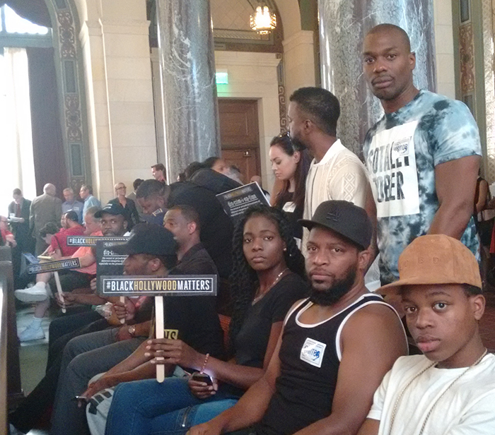 Supporters of the Cosmo nightclub in Hollywood sit in a City Council committee hearing Aug. 16 where the club owner was appealing a city decision to withdraw the club’s operating permit. Club supporters say the Los Angeles Police Department discriminates against Cosmo and other Hollywood clubs that cater to black and Latinos. (Photo by Tami DeVine)