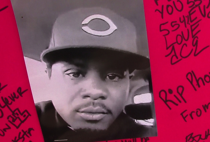 A picture of a young Donta Taylor is part of a memorial on a chain-link fence near where the 31-year-old Compton man was shot and killed by sheriff deputies Aug. 25. (Photo by Tami DeVine)